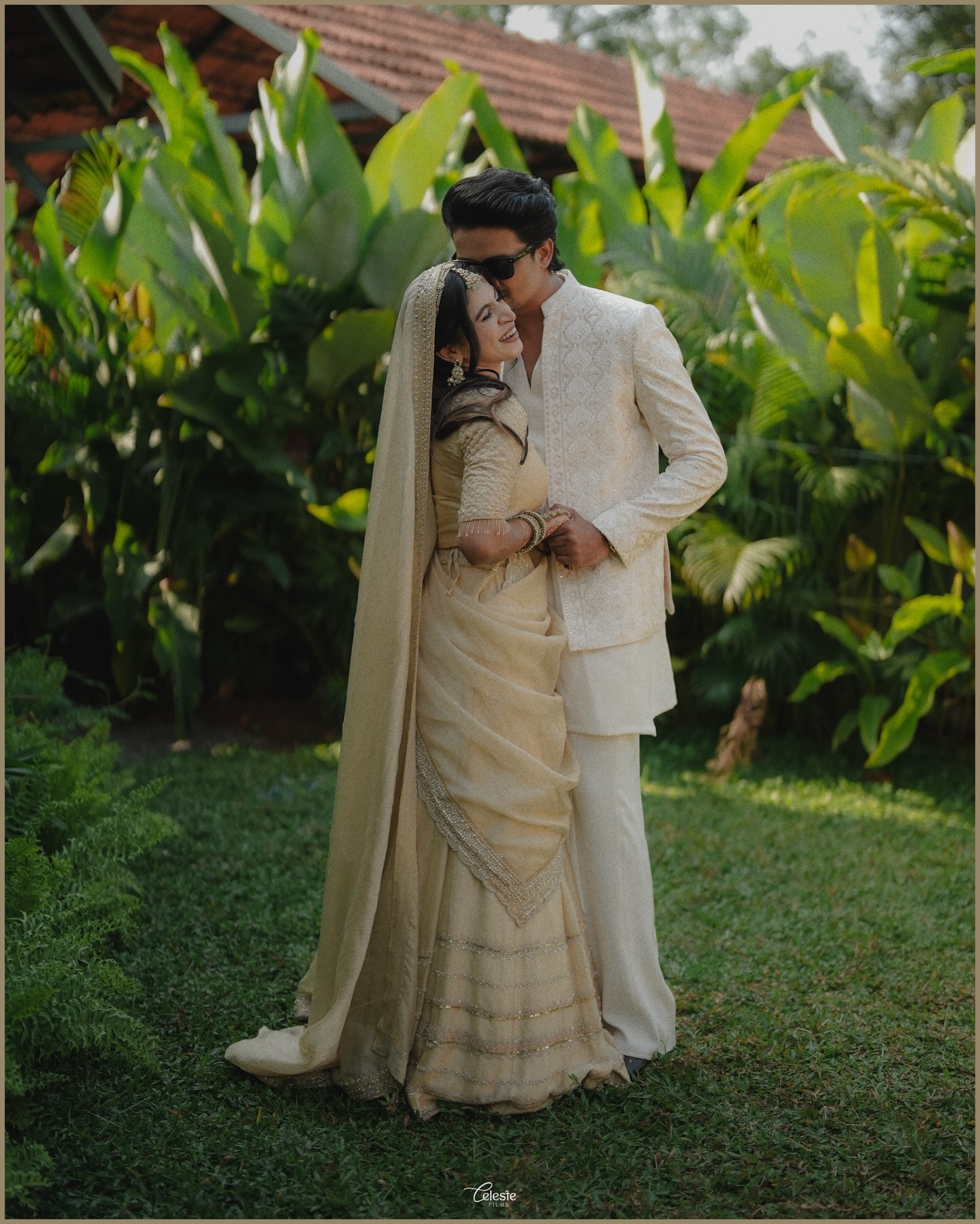 Wedding couple embracing in a tropical garden